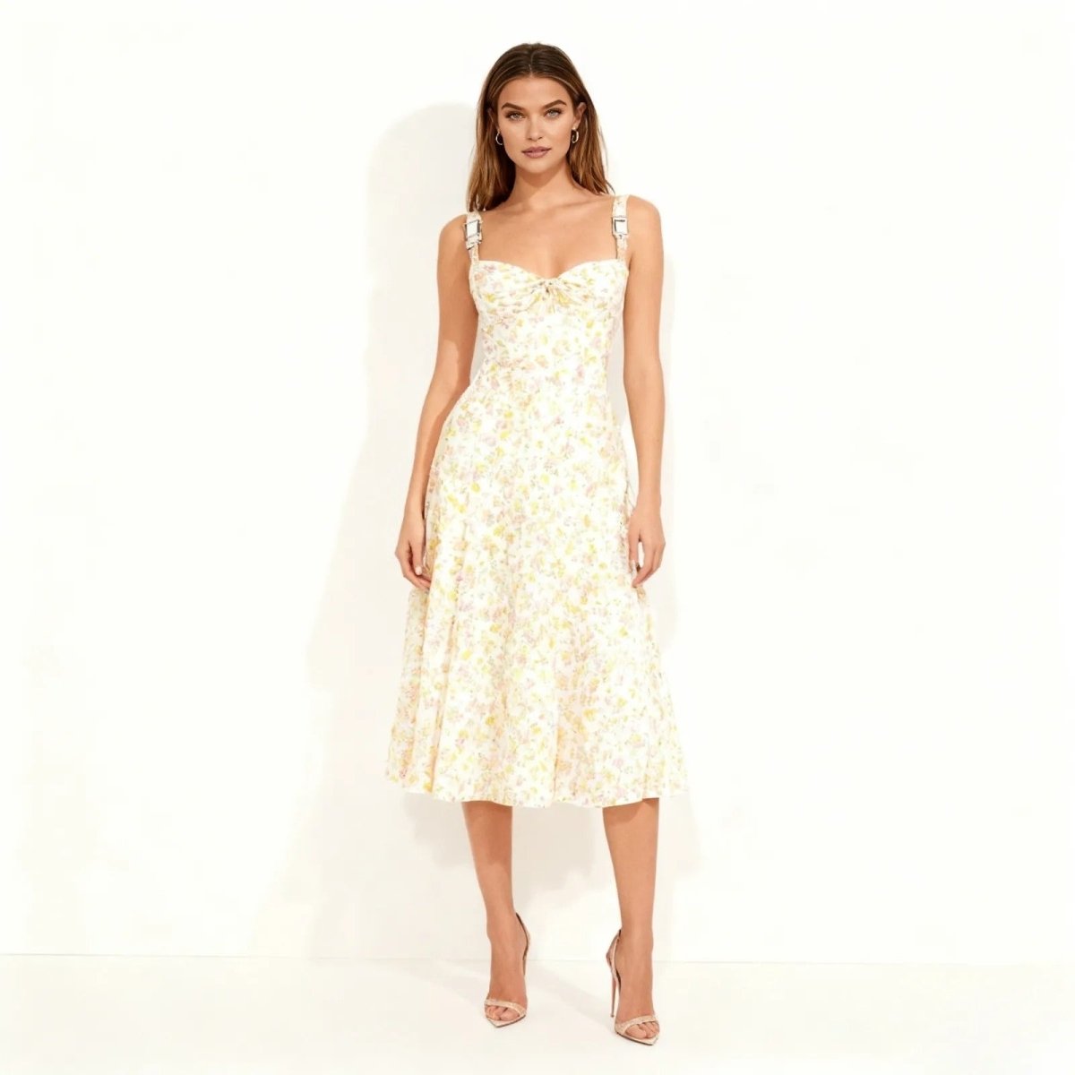 Woman wearing a ivory kouvr floral dress on a white background