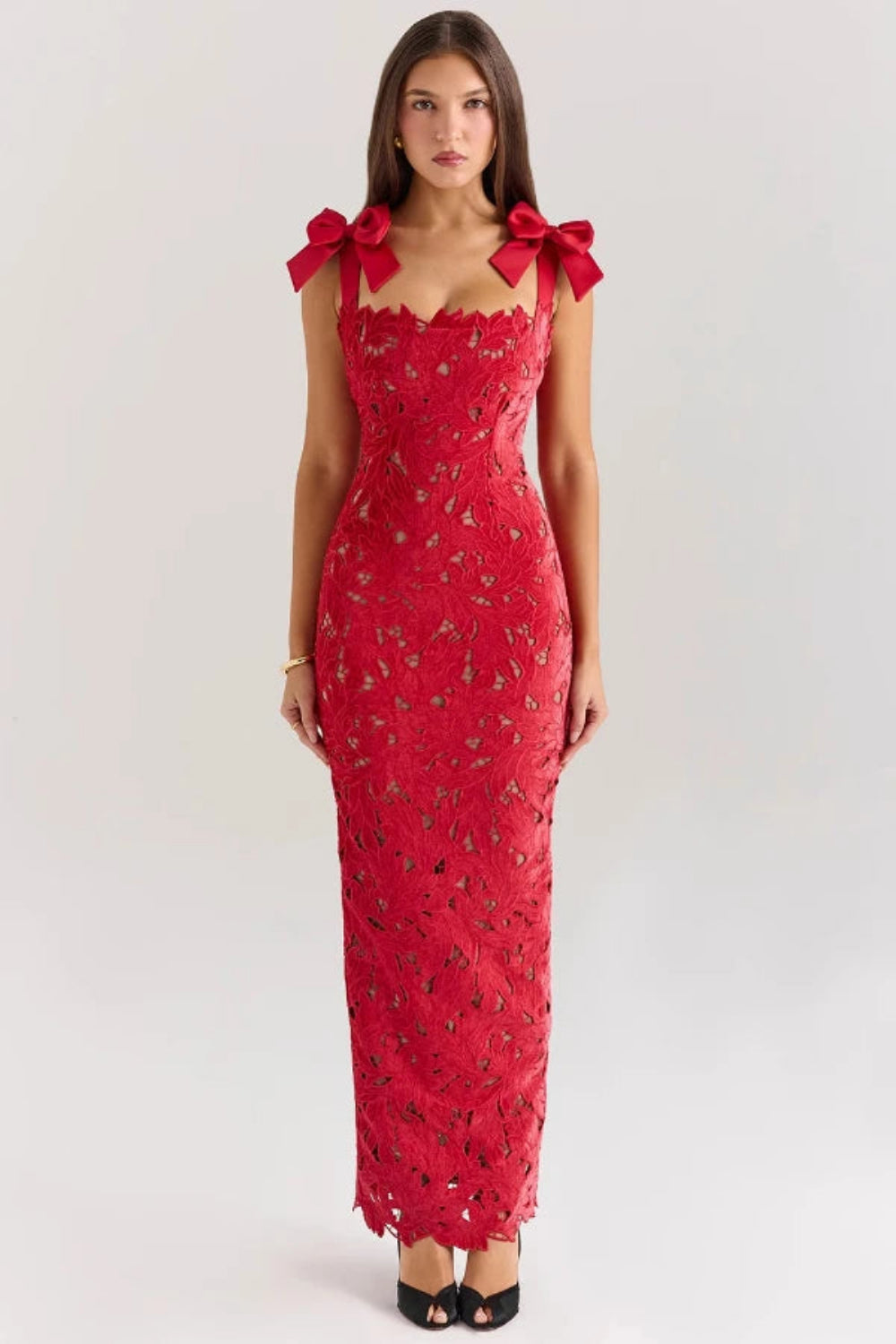 Back view of the Kouvr Fashion Penelope lace gown showing the rear slit and bow strap detail