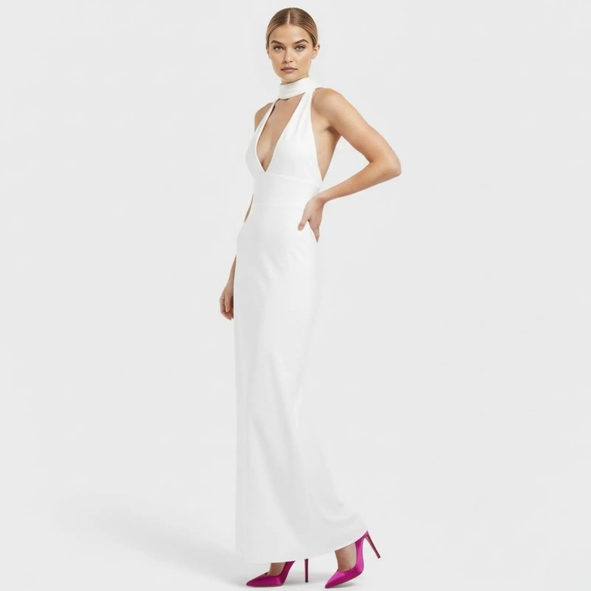 Model in a three-quarter view of the Kouvr Fashion Sharon white formal gown, with hand on hip, highlighting the fitted column shape.