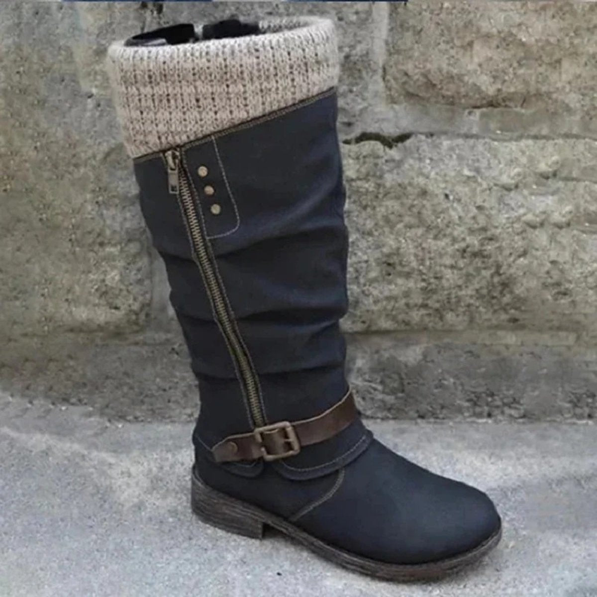 Outer side view of the black Kouvr Fashion boot, highlighting the decorative zipper, stud details, and brown ankle strap with buckle.