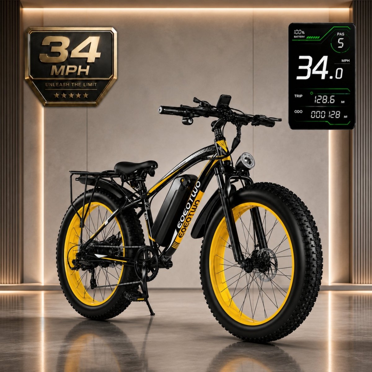 The yellow accented Kouvr 1500W electric mountain bike parked in a luxury studio showroom beside a digital display highlighting a 34 MPH top speed.