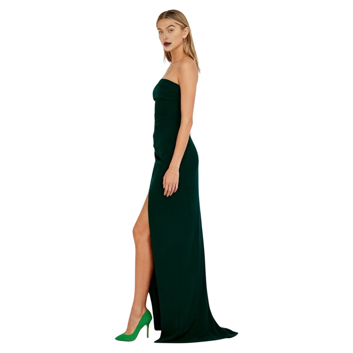 Woman wearing a green kouvr strapless gown with a high slit on a white background