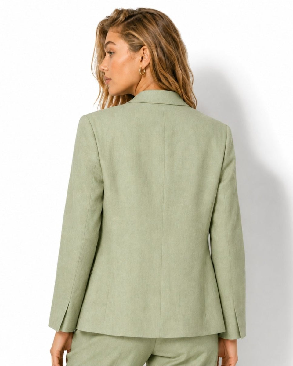 Back view of women's tailored light green linen suit jacket with center back vent