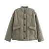 Flat lay product shot of the Kouvr Harmony quilted jacket in sage green, showing the button front, patch pockets, and leopard print interior collar lining.