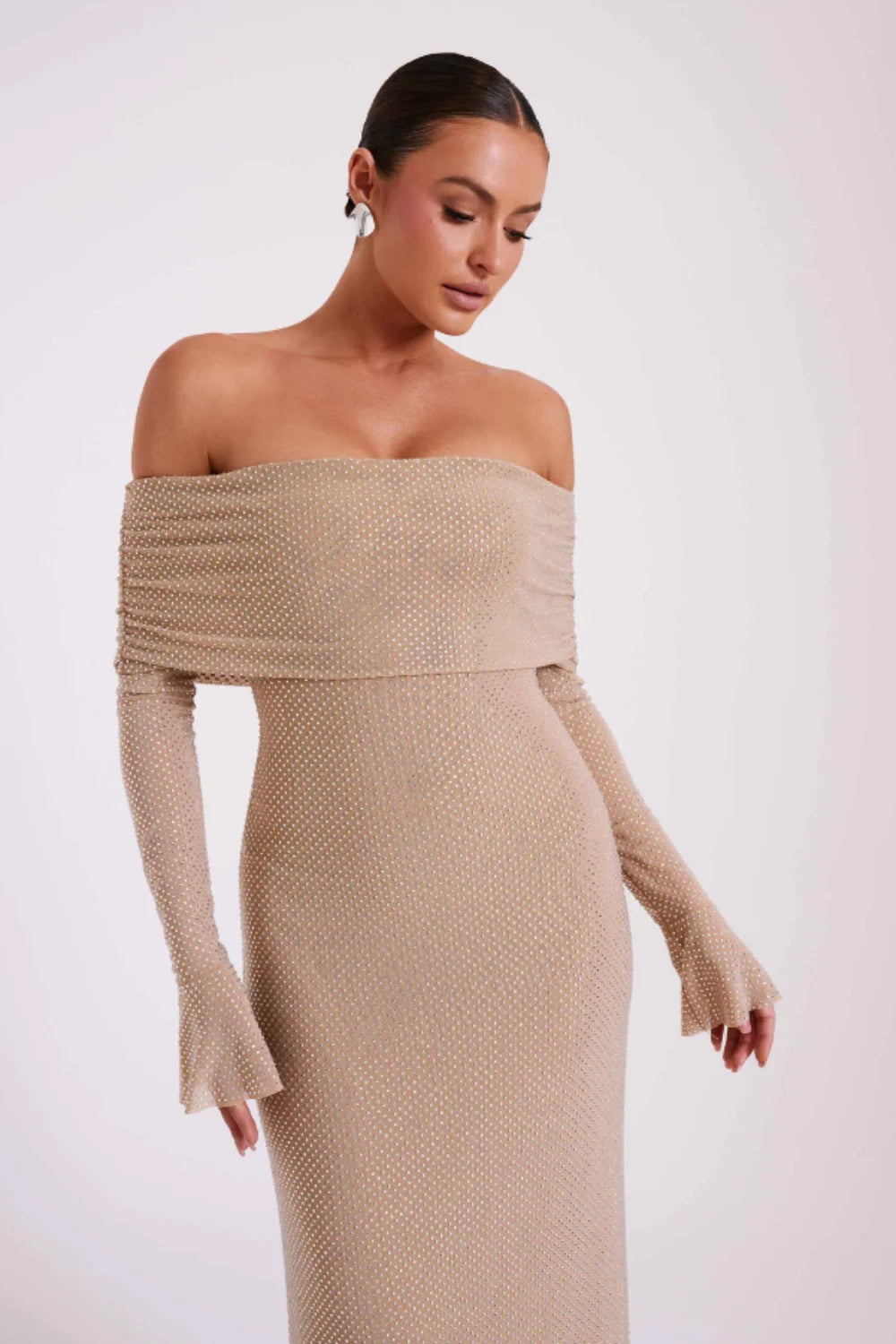 Model from behind in Kouvr Jada Beige off-the-shoulder formal gown with flare sleeves