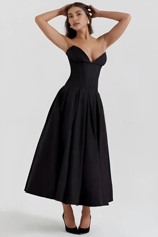 Model wearing Kouvr Fashion's black strapless corset midi dress for a formal event
