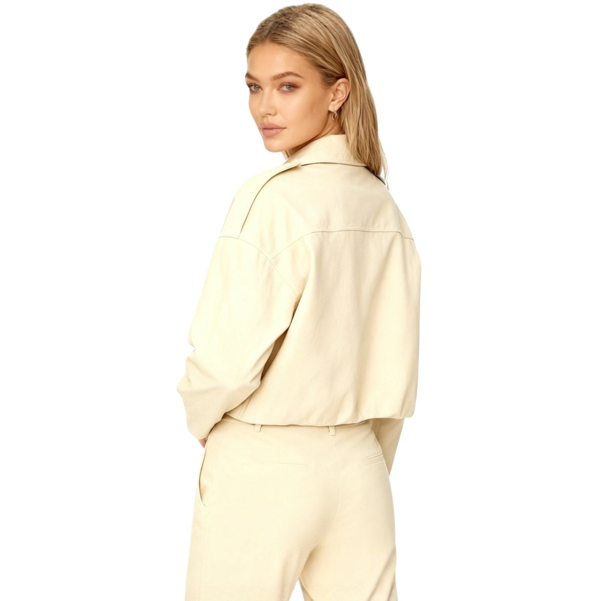 Back view of a model in the Kouvr Leilani cropped suede jacket, highlighting the back yoke and fit.