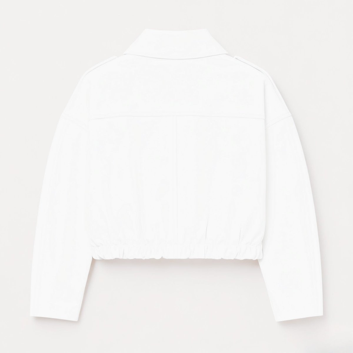 Close-up detail of the gold-tone zipper and collar on the Kouvr Leilani white faux leather jacket.