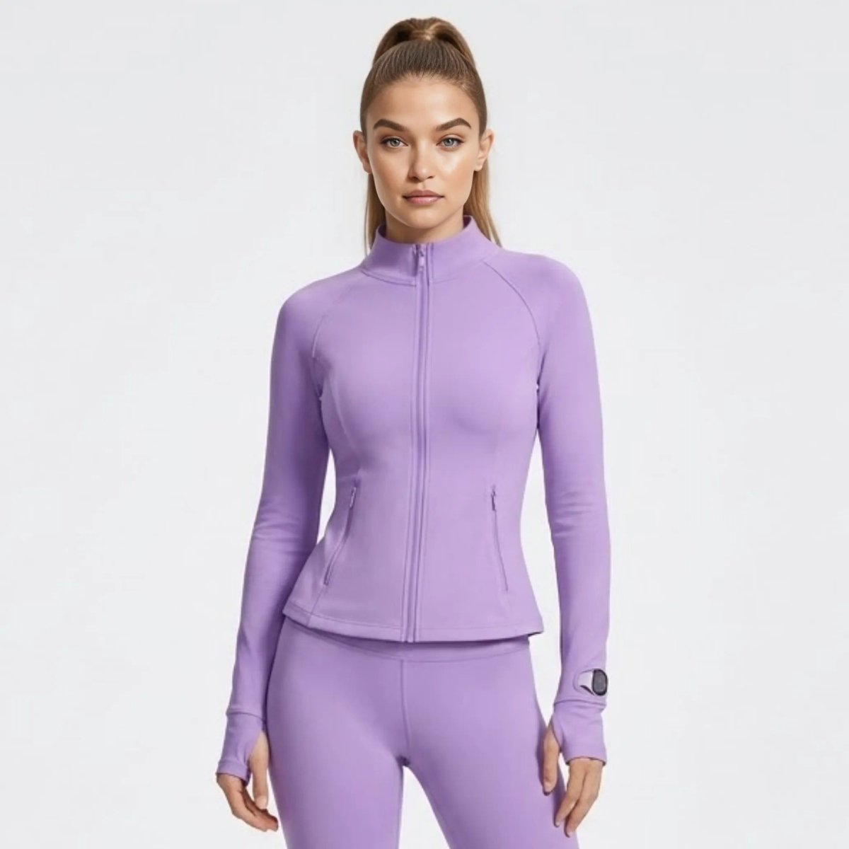 Model wearing Kouvr premium light purple fitted running jacket with zip front and thumbholes.