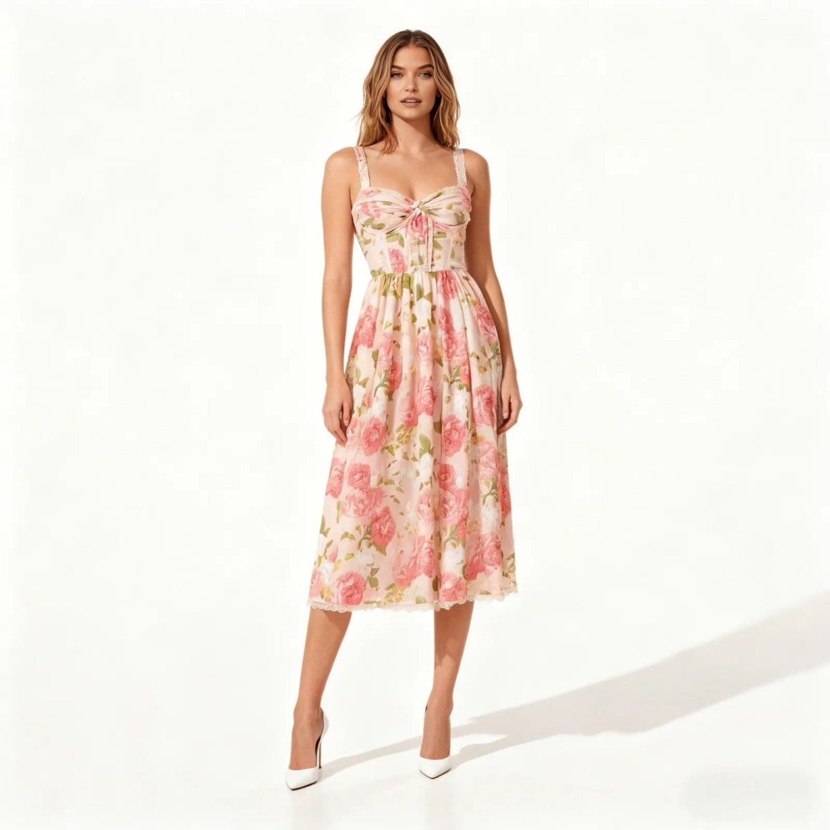 Woman wearing a pink kouvr floral dress on a white background