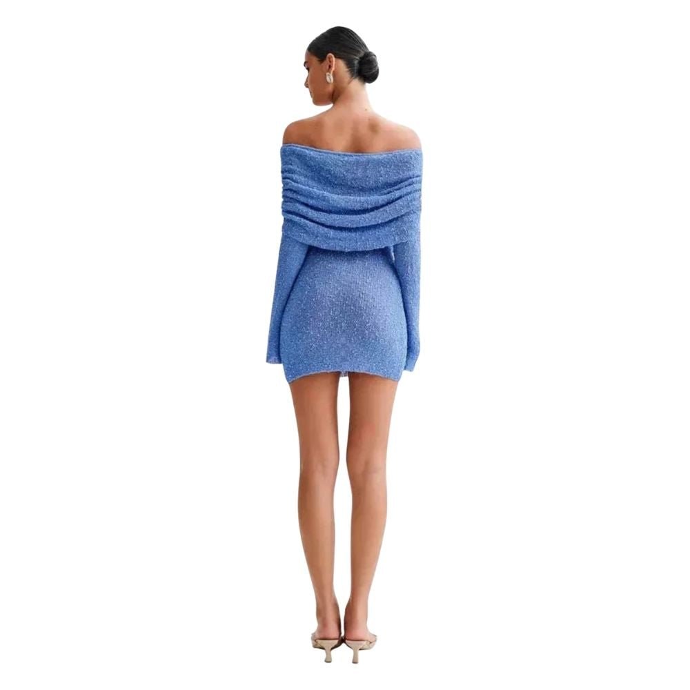 Woman wearing a blue kouvr off-shoulder dress on a white background