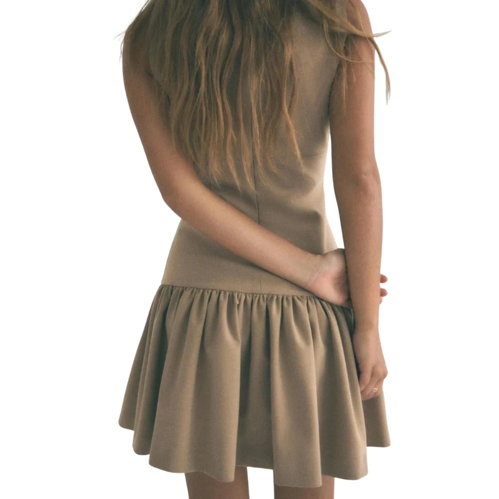 Woman wearing a khaki Kouvr dress on a white background