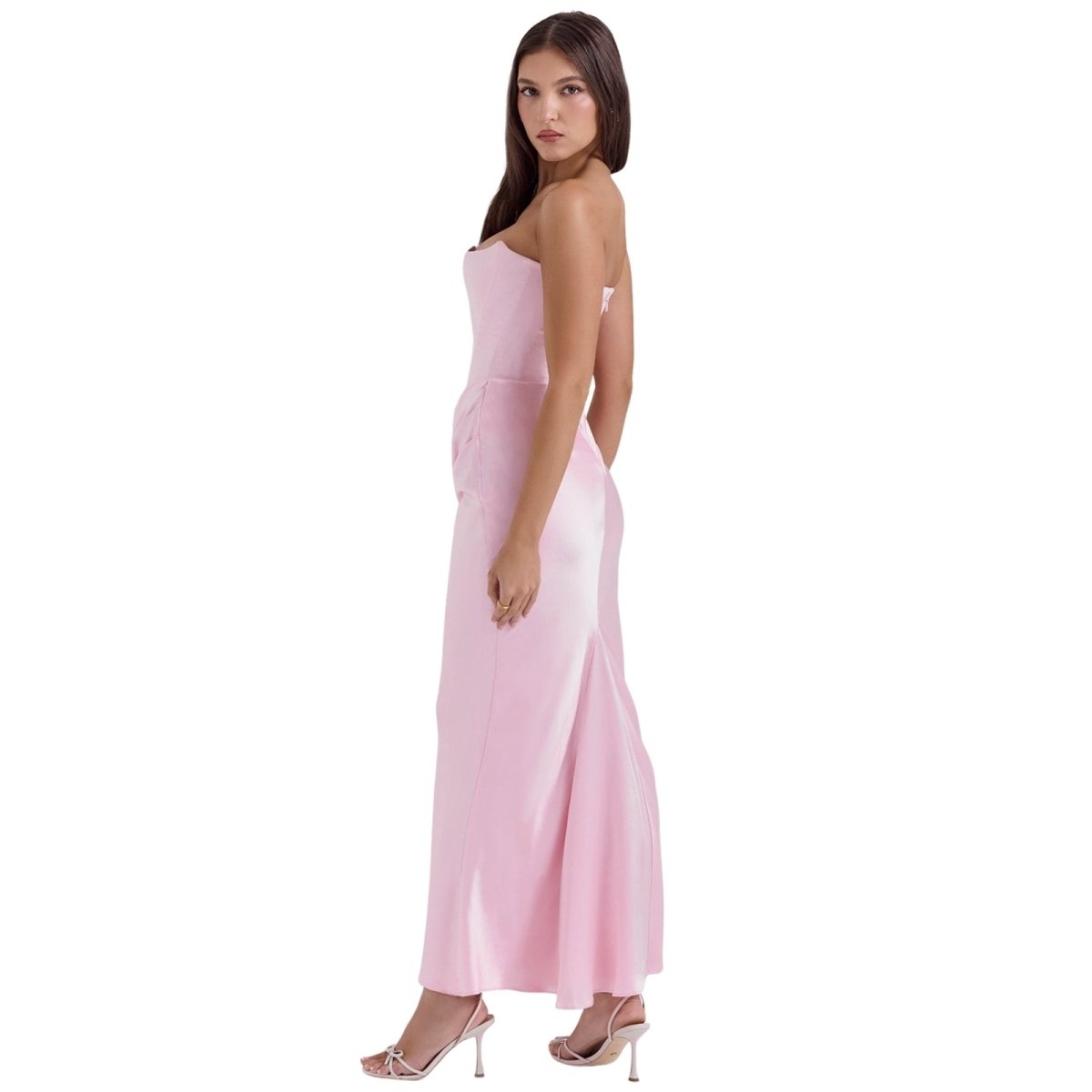 Woman wearing a pink Kouvr strapless gown on a white background