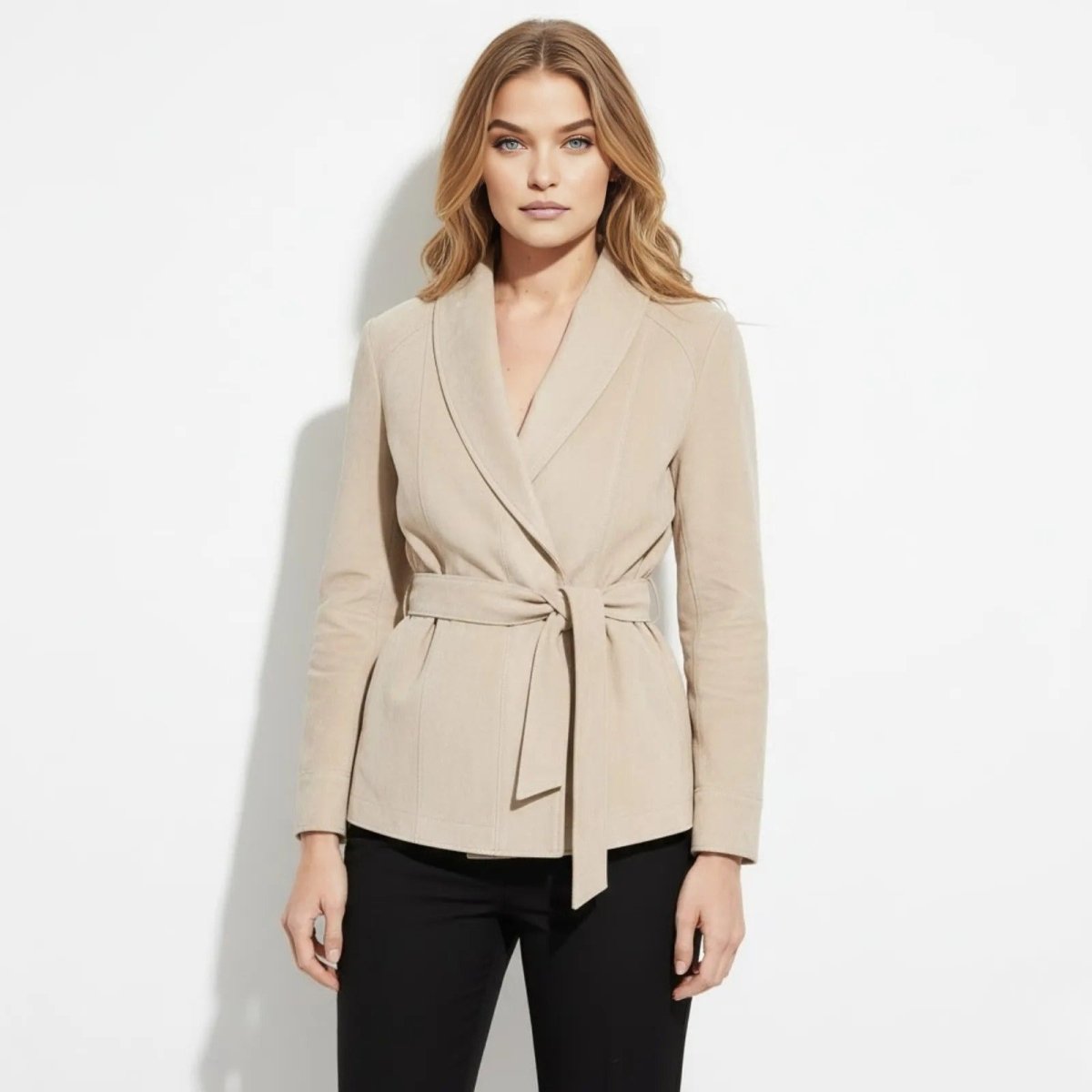 Woman wearing the Kouvr Suede Belted Wrap Jacket in light beige, front view showing the shawl collar and tie-waist belt.