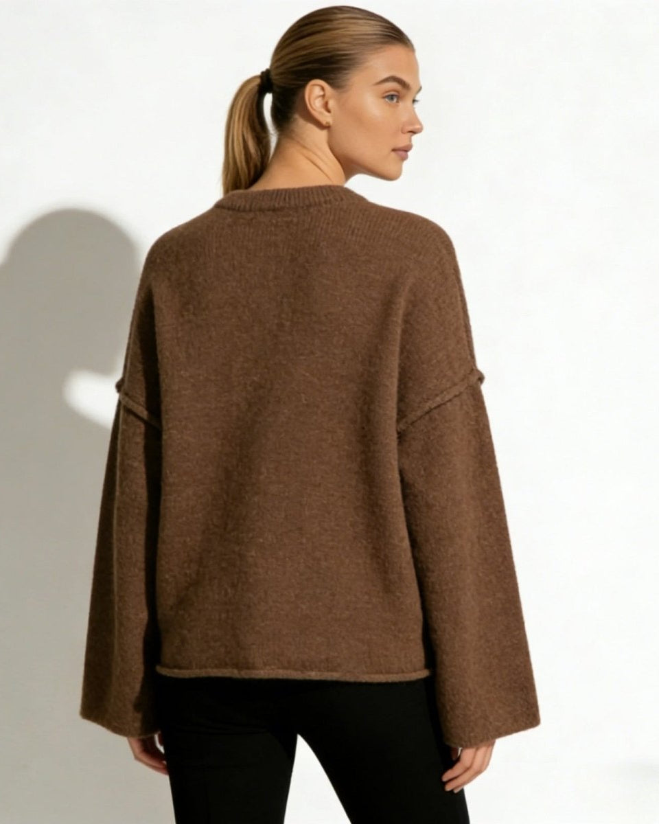 Back view of the Krystal oversized knit sweater, highlighting its boxy silhouette and clean lines in a warm brown hue.