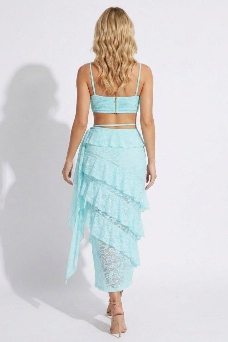 Woman wearing a light blue lace outfit on a white background