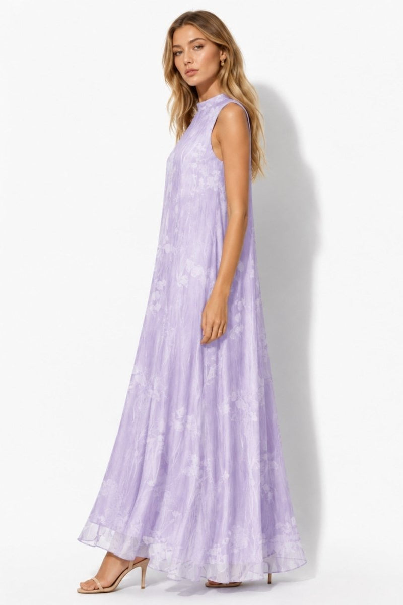 Side profile of a flowing light purple organza trapeze maxi dress with subtle botanical print