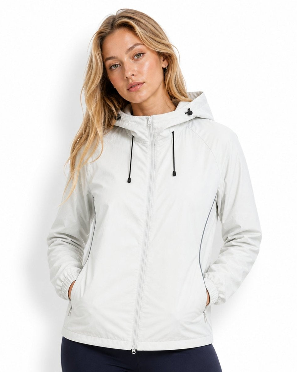 Female model wearing an affordable luxury light grey zip-up windbreaker jacket, showcasing a relaxed fit and versatile styling.