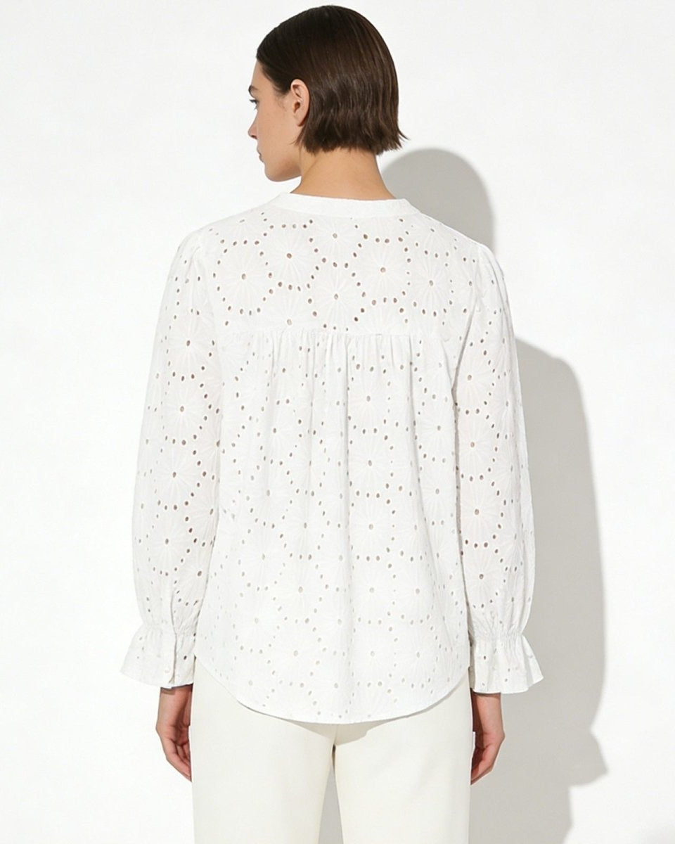 Back view of the white cotton blouse, highlighting the gathered yoke and intricate lydia pattern.