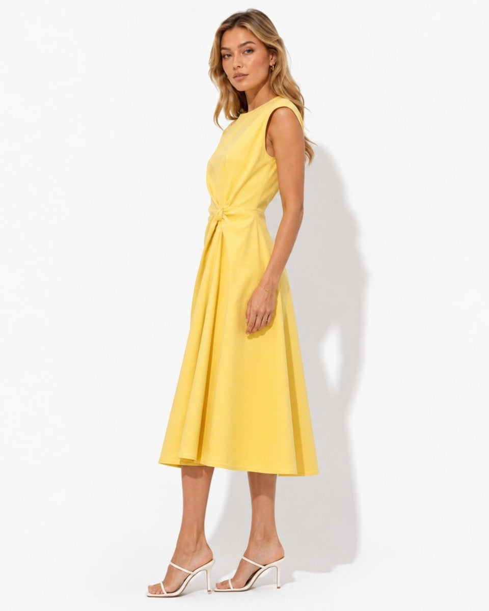 Side profile of luxury yellow A-line flared midi dress showing precision waist draping and structured sleeveless silhouette.