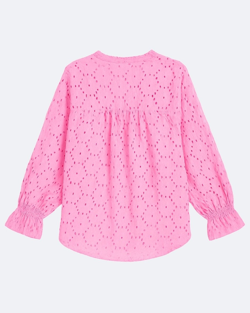 Flatlay product shot of the back of the pink eyelet blouse, showcasing the full pattern and curved hem.
