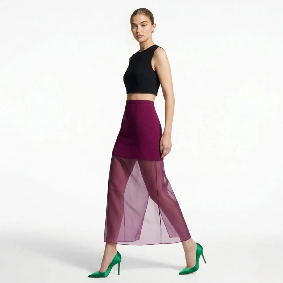 Side profile of female model walking in magenta illusion maxi skirt showing sheer leg movement and styling.