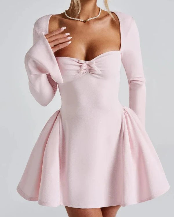 Pink dress with long sleeves on a plain background