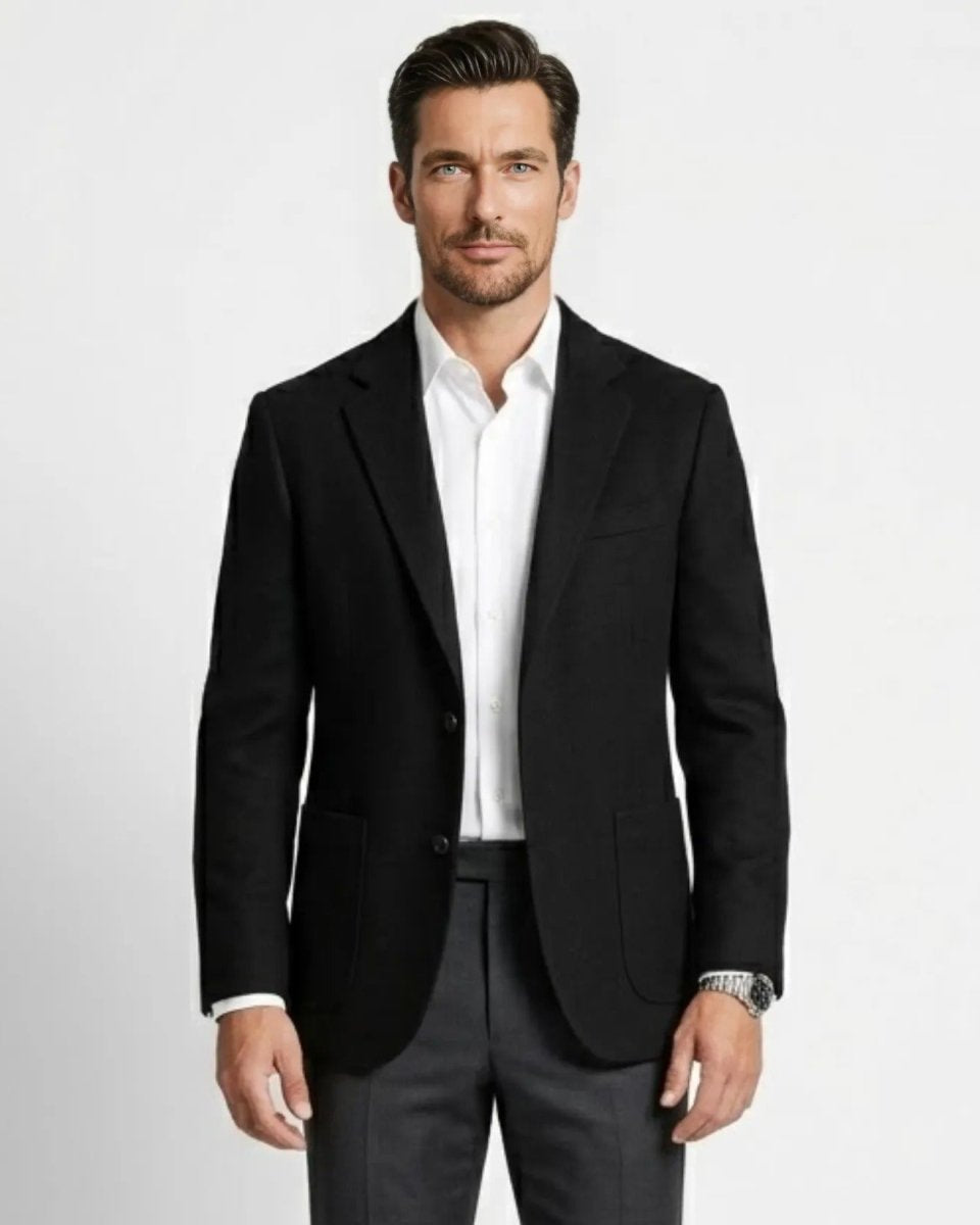 Men's black tailored fit wool blazer worn by a male model over a crisp white dress shirt.