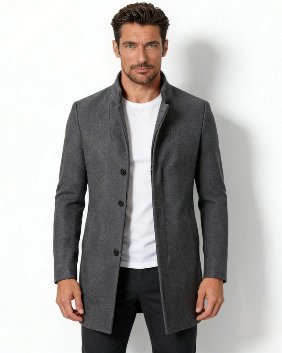 Model wearing the men's charcoal grey wool blend stand collar overcoat in a slim fit, shown from the front over a white t-shirt.