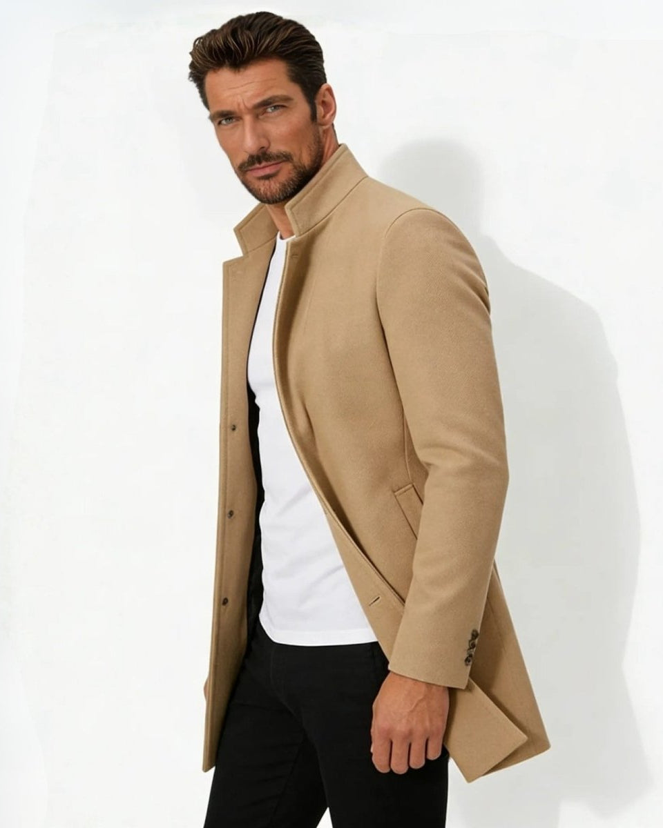 Side profile of a man wearing the khaki wool topcoat showing its tailored fit and sleeve button details.