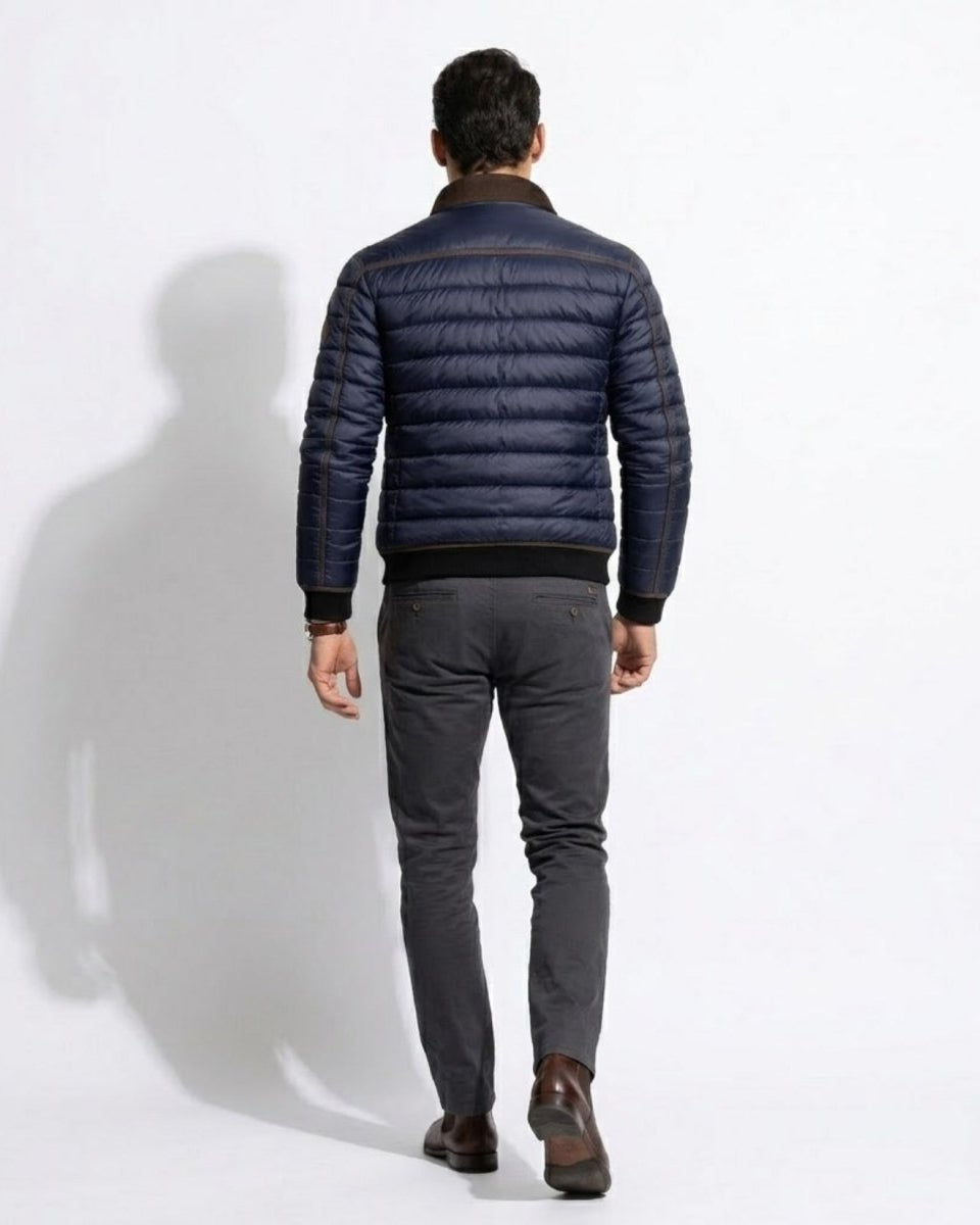 Back view of male model demonstrating the tailored fit and black ribbed hem of the Fenlo Form winter outerwear jacket.