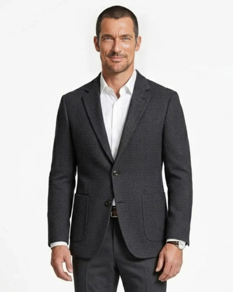 Close up front view of a man wearing a plaid textured tailored blazer over a white dress shirt.