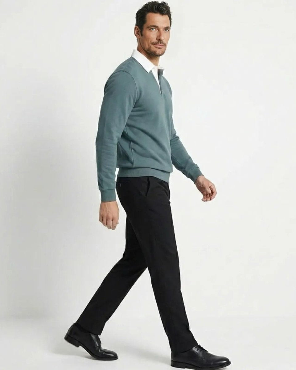 Side view of a man walking in a grey blue contrast collar polo sweatshirt, showing the tailored fit and silhouette.