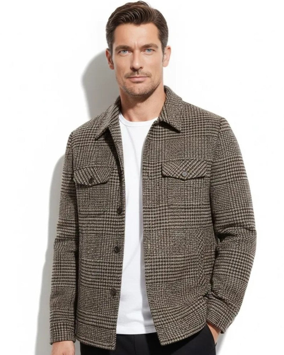 Model wearing the men's brown and black houndstooth wool shacket layered over a white t-shirt and black pants.
