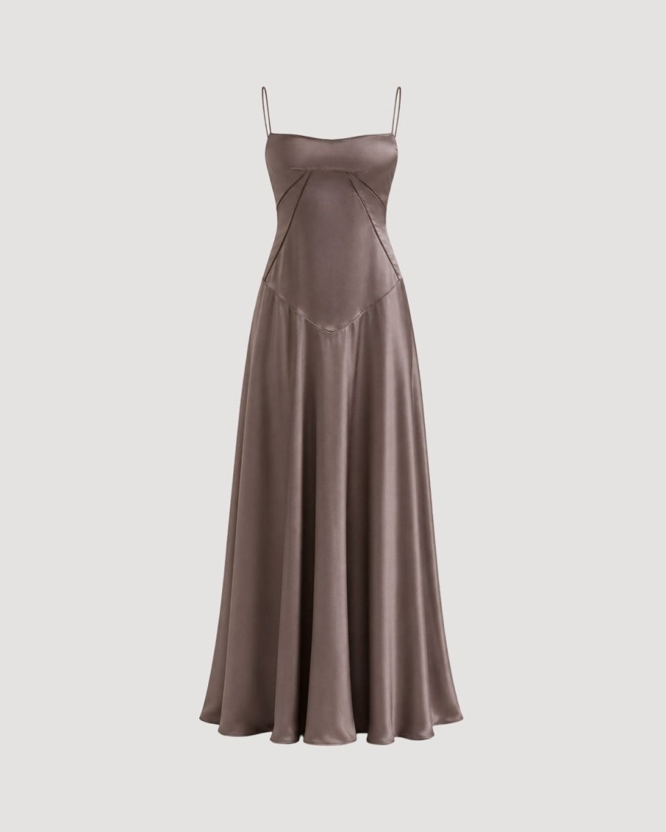 A floor-length satin slip dress in a muted taupe-brown color, featuring thin spaghetti straps, a structured sweetheart neckline, and a flared skirt, shown against a solid light gray background.