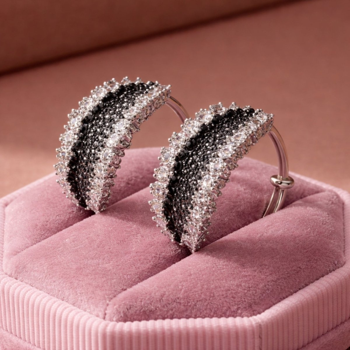 Close-up of a model wearing the Kouvr Midnight Lark luxury sapphire and diamond statement hoop earrings, showcasing their size and elegant look.