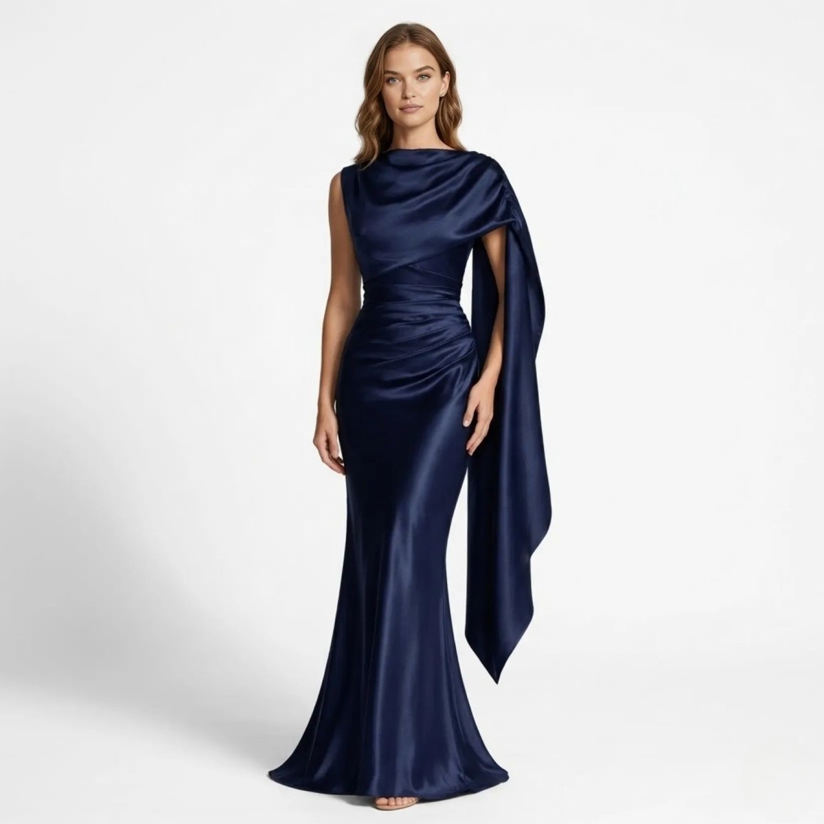 Woman wearing Kouvr navy blue satin asymmetric cape gown with draped cowl neckline for black tie events.