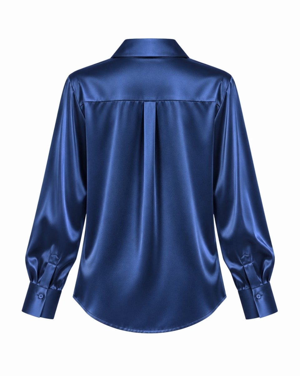 A royal blue silk long-sleeve button-up shirt shown from the back, featuring a subtle sheen and a centered back pleat, set against a plain white background.