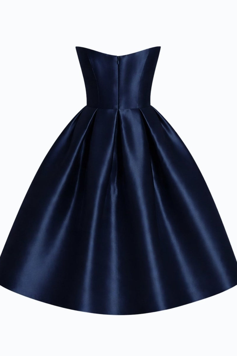 Product back view of luxury structured navy evening gown showing bodice seams and elegant drape.