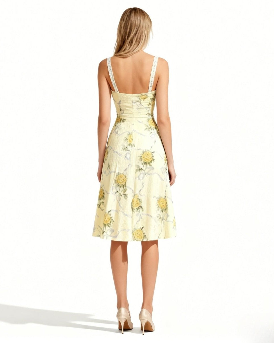 Woman wearing a light yellow floral dress on a white background