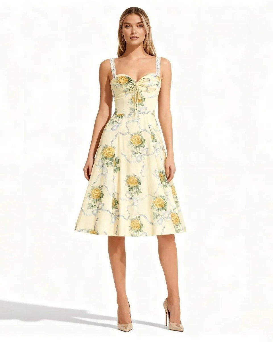 Woman wearing a light yellow floral dress on a white background