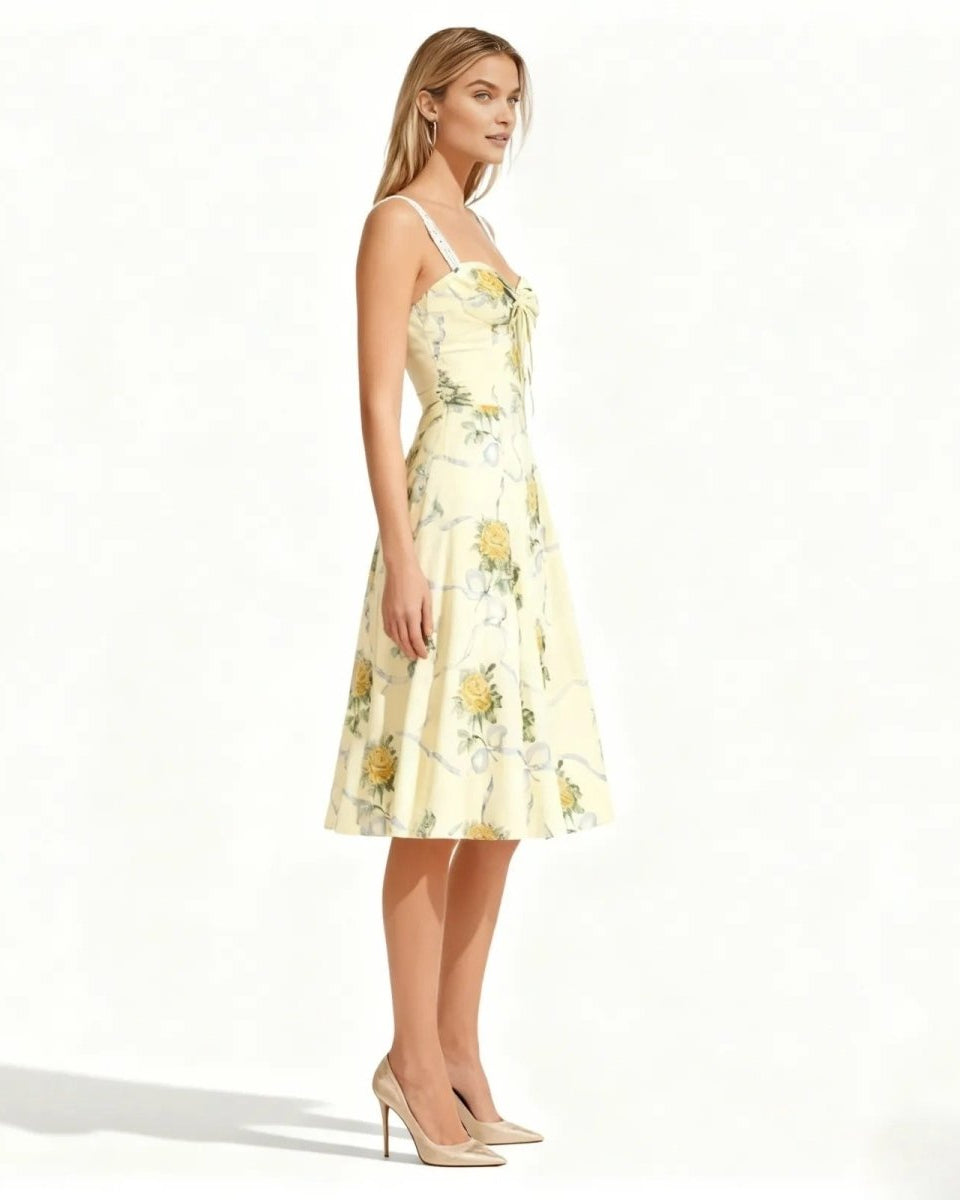 Woman wearing a light yellow floral dress on a white background