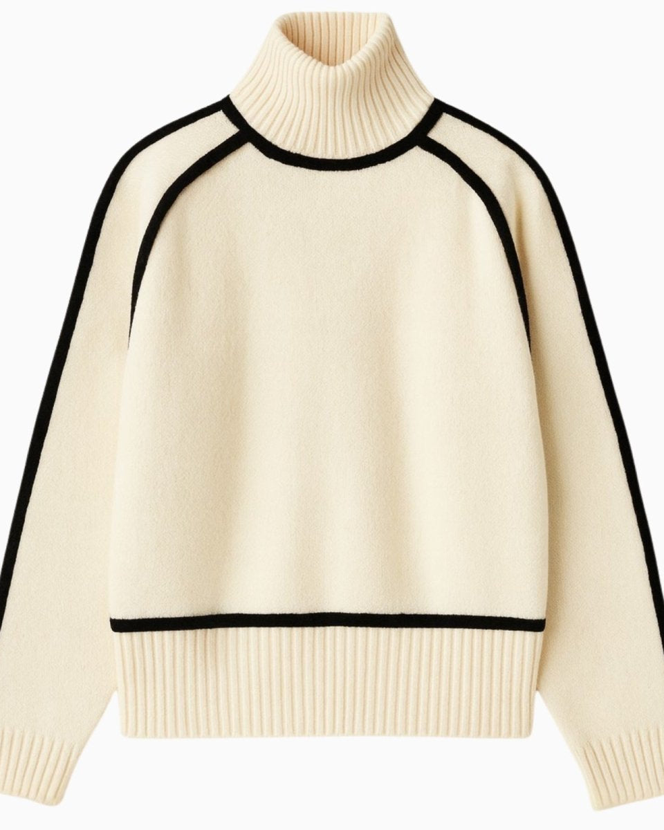Product shot of a women's cream turtleneck sweater with black piping detail along the funnel neck, raglan sleeves, and body.