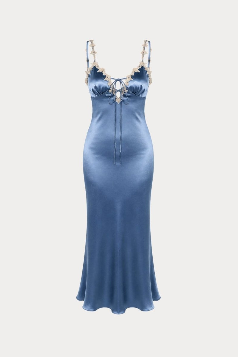 Isolated view of slate blue satin slip dress highlighting delicate floral lace neckline and bust gathering.