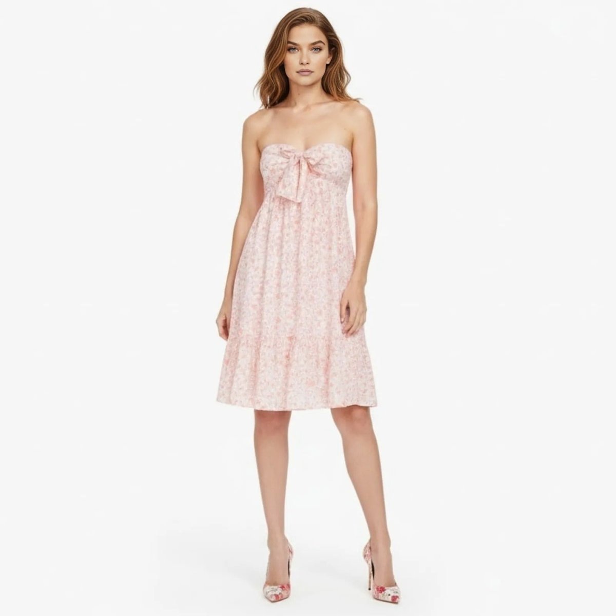 Model wearing the Kouvr Fashion Orange floral strapless mini dress with a bow on the bust, shown from the front against a white background.