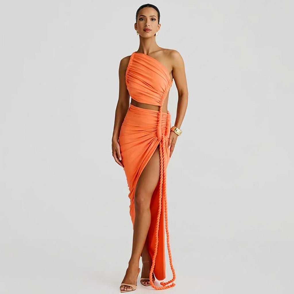 Front view of a model wearing a vibrant orange one-shoulder maxi dress with a side cutout and high thigh slit by Kouvr.