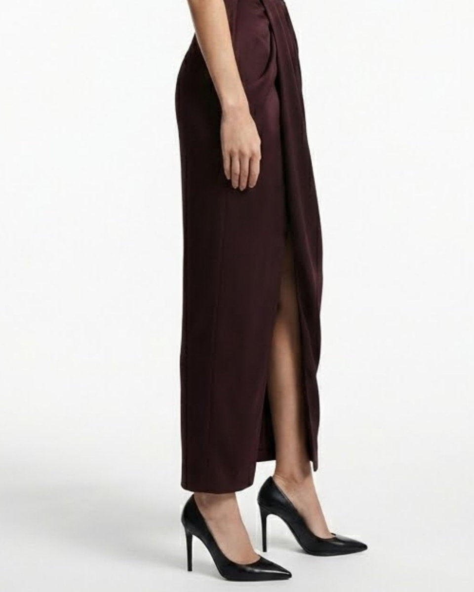 Close-up detail of the luxurious satin fabric and elegant front leg slit on the Theia draped pant.