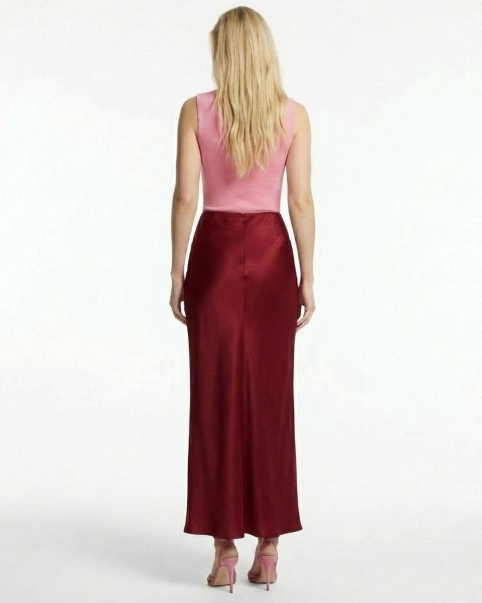 Back view of The Ourania red satin maxi skirt, highlighting the seamless construction.