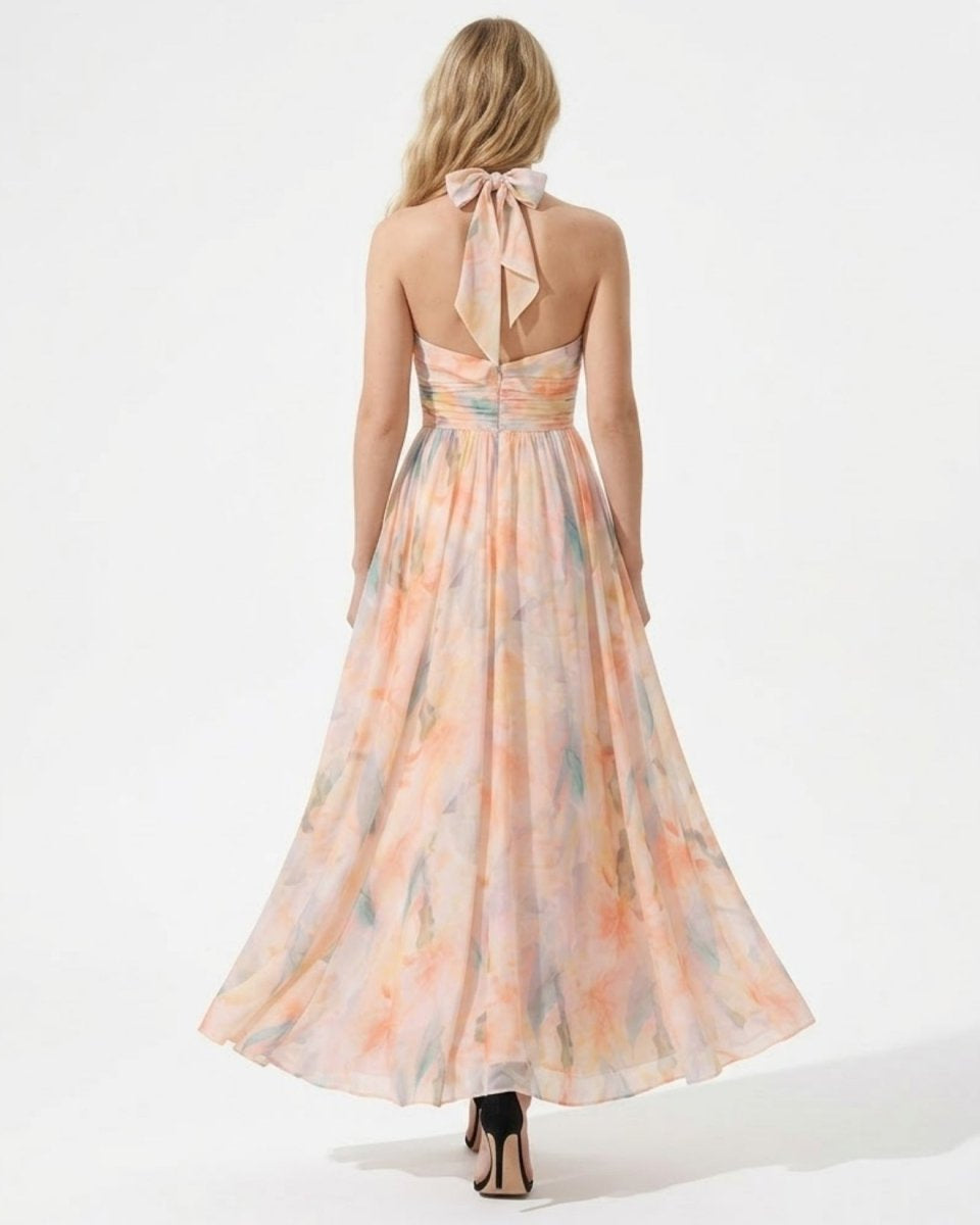 Back view of the floral halter maxi dress showing the elegant bow tie neck and open back.