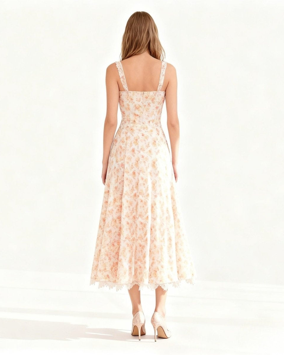 Back view of the peach dress highlighting the smocked back panel and delicate lace shoulder.